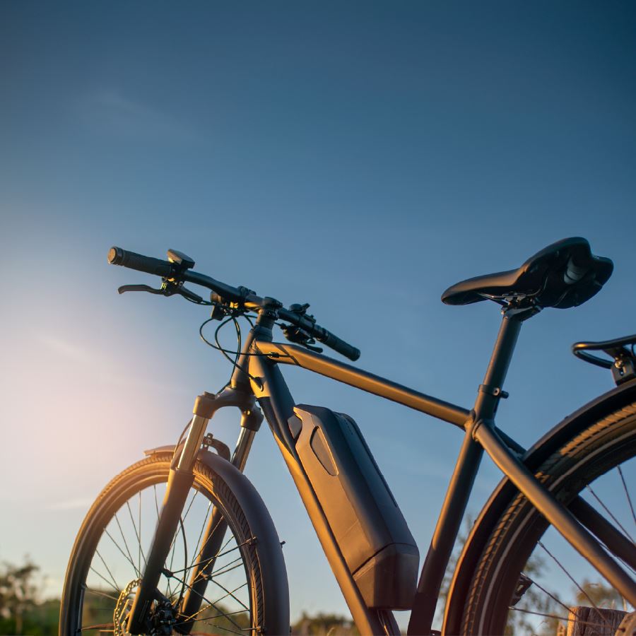 A e-bike with a sun setting in the background
