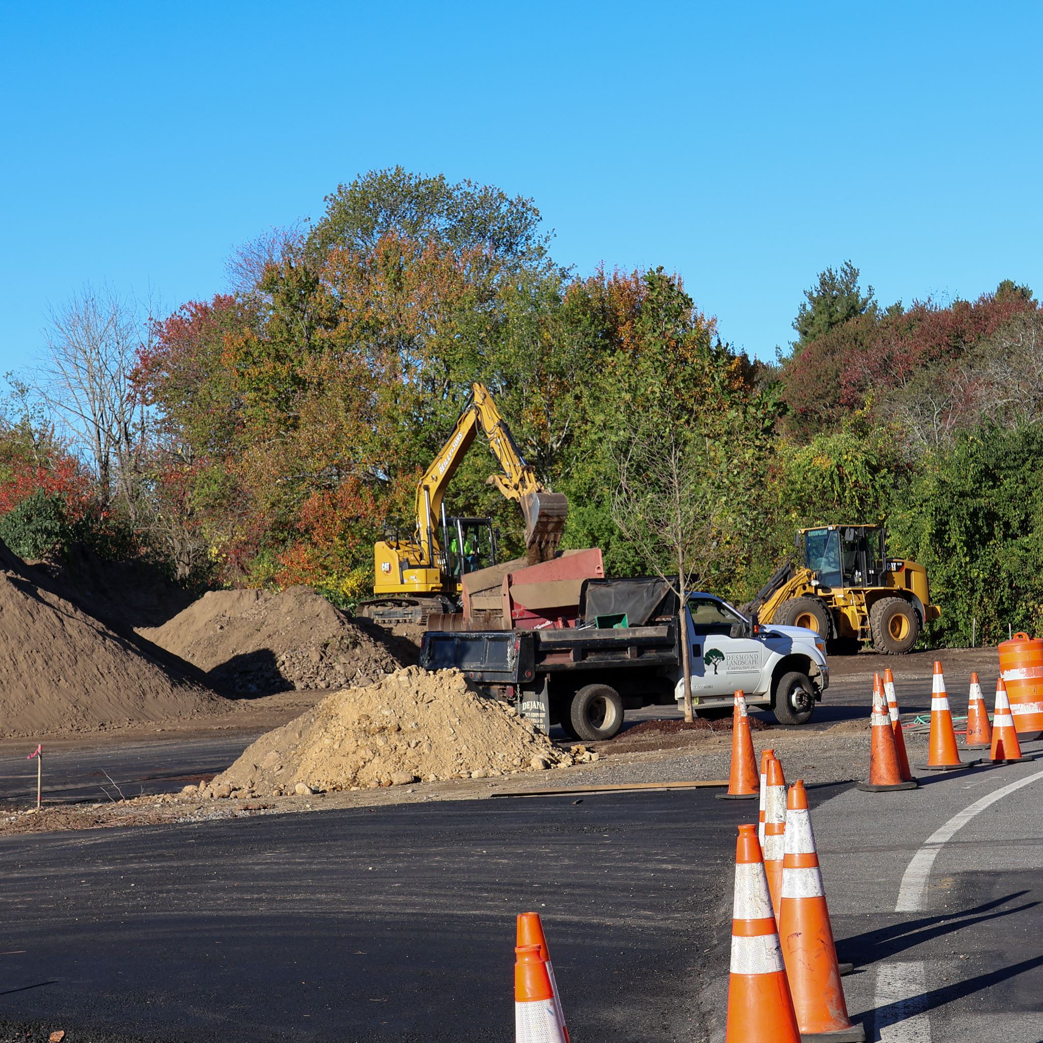 Construction activity underway at the Chandler Road Recreation area. Several trucks in a parking lot